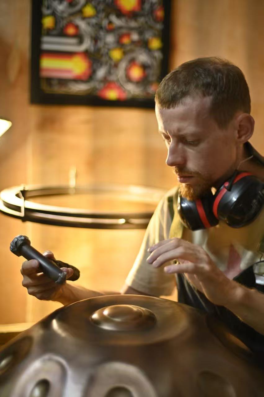 Vitaliy I.V.A. working on a Handpan
